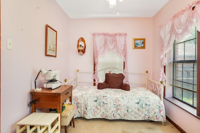 carpeted bedroom with multiple windows