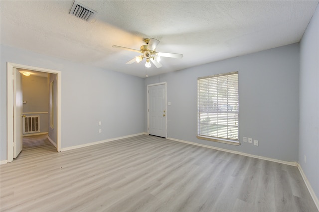 spare room featuring ceiling fan, a textured ceiling, and light hardwood / wood-style flooring