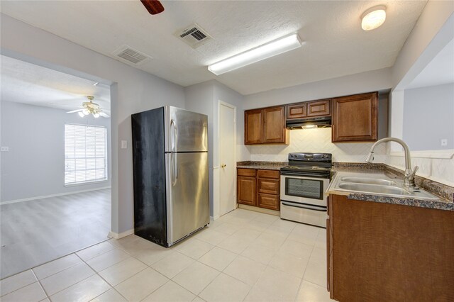 kitchen featuring a textured ceiling, sink, stainless steel appliances, light tile patterned floors, and ceiling fan