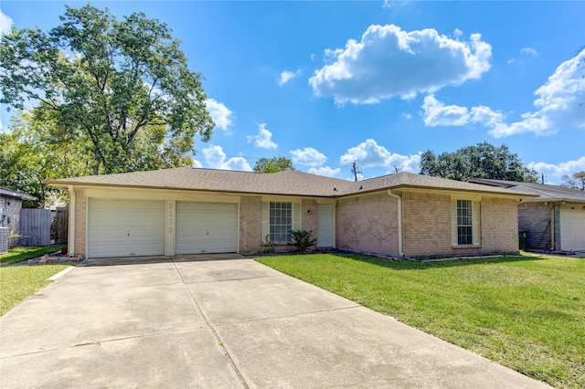 ranch-style home featuring cooling unit, a garage, and a front lawn