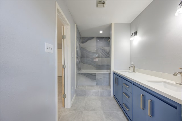 bathroom featuring tile patterned floors, vanity, and tiled shower