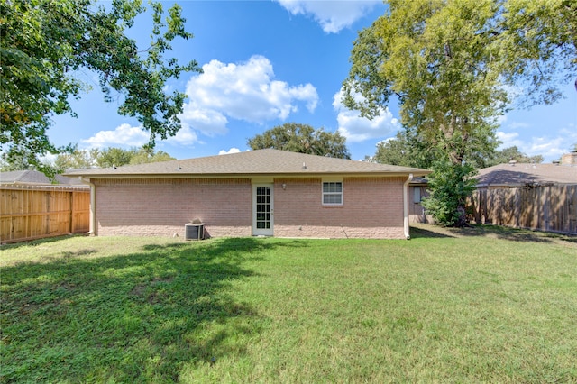 rear view of property with a yard