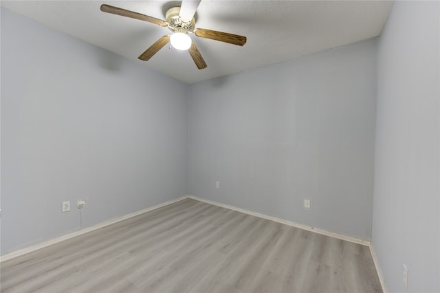 empty room featuring light wood-type flooring, a textured ceiling, and ceiling fan