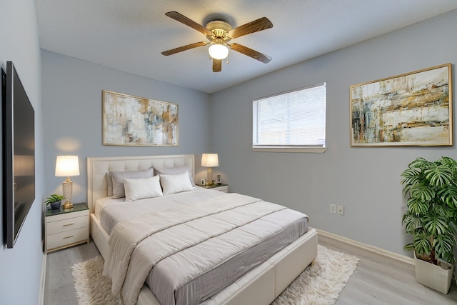 bedroom featuring light hardwood / wood-style floors and ceiling fan