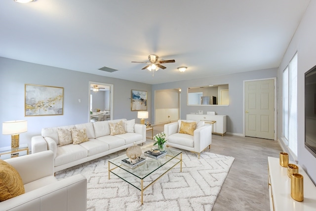 living room featuring light wood-type flooring and ceiling fan