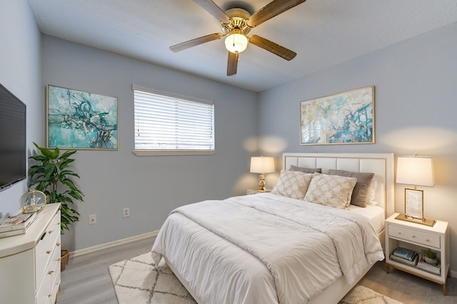 bedroom featuring ceiling fan and light wood-type flooring