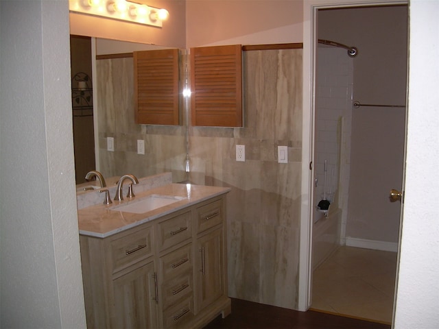 bathroom with tub / shower combination, vanity, and tile patterned floors