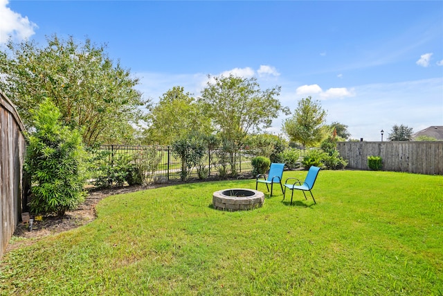 view of yard with a fire pit