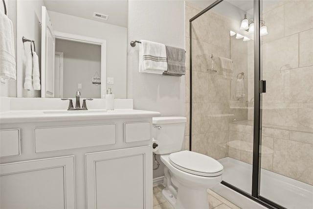 bathroom with vanity, toilet, an enclosed shower, and tile patterned floors