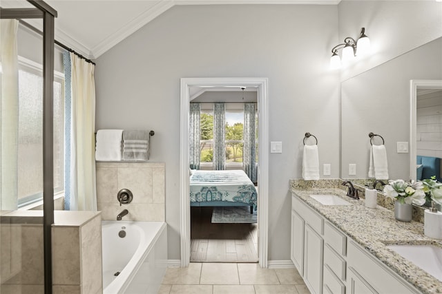 bathroom featuring vanity, lofted ceiling, ornamental molding, a tub, and tile patterned flooring