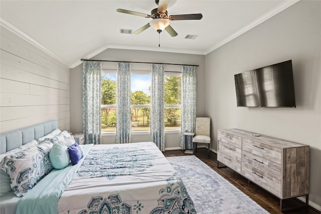 bedroom with dark wood-type flooring, vaulted ceiling, wood walls, ornamental molding, and ceiling fan