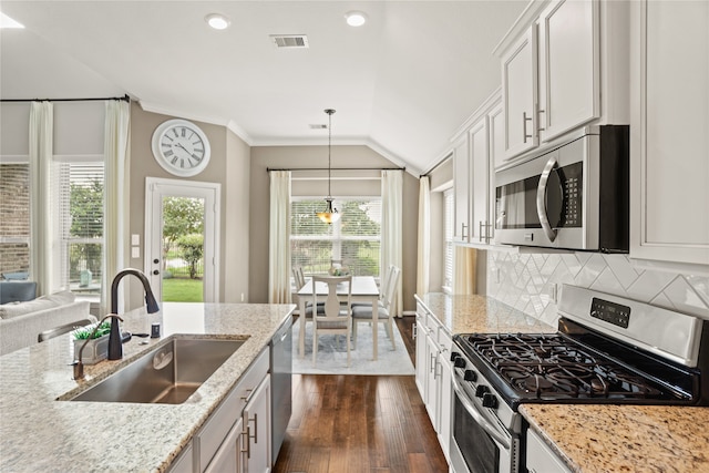 kitchen featuring pendant lighting, dark hardwood / wood-style floors, sink, white cabinetry, and appliances with stainless steel finishes