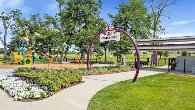 surrounding community with a lawn and a playground