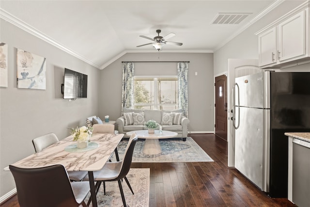 dining area with ceiling fan, lofted ceiling, crown molding, and dark wood-type flooring