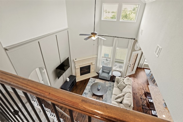 living room featuring a high ceiling, dark hardwood / wood-style floors, and ceiling fan