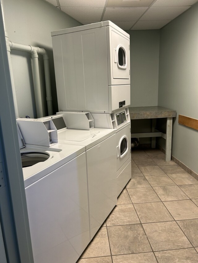 6102 Seawall Blvd Unit 375, Galveston, TX 77551 - community laundry room featuring stacked washing machine and dryer, washing machine and dryer, baseboards, and light tile patterned flooring