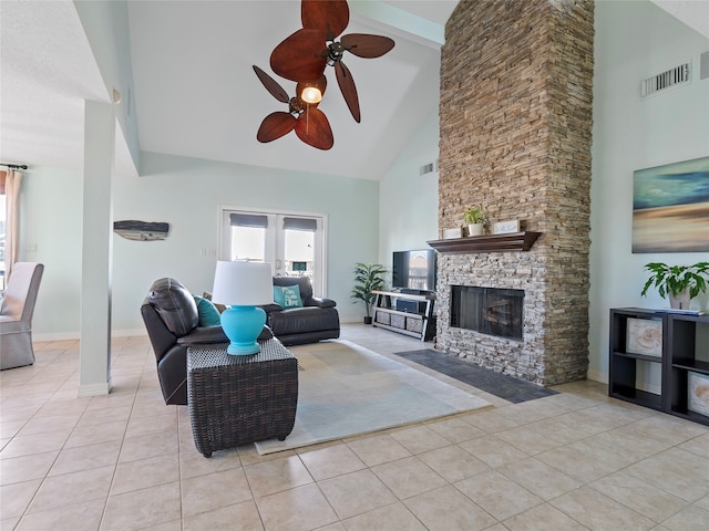 tiled living room featuring ceiling fan, high vaulted ceiling, and a fireplace