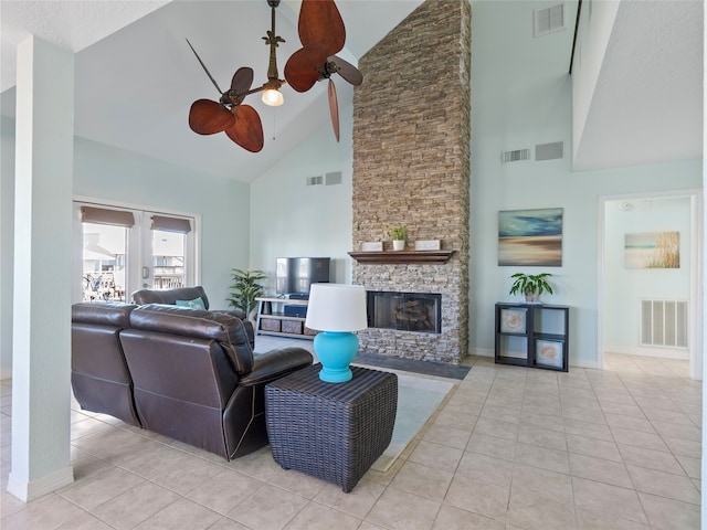 living room featuring light tile patterned floors, a fireplace, high vaulted ceiling, and ceiling fan