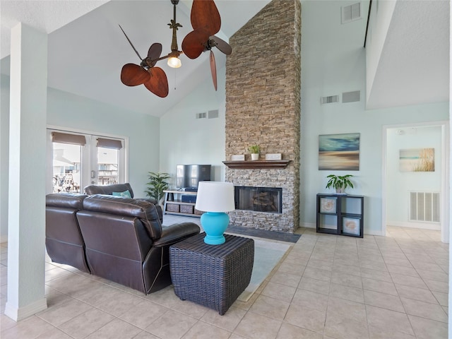 tiled living room with a fireplace, visible vents, and high vaulted ceiling