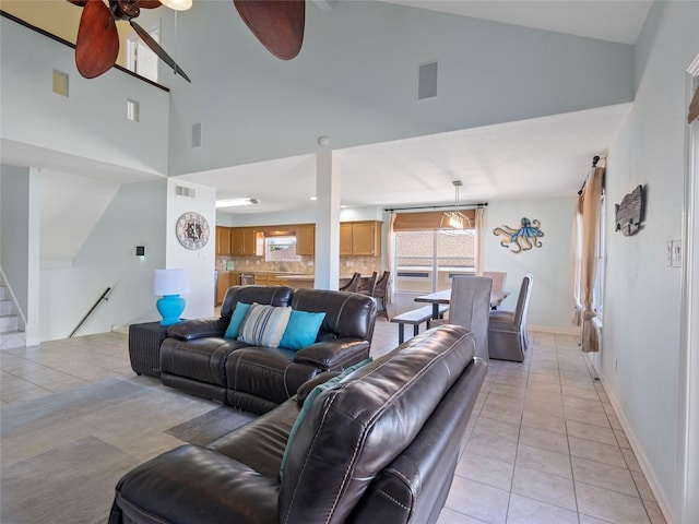 living room with visible vents, high vaulted ceiling, light tile patterned floors, and ceiling fan