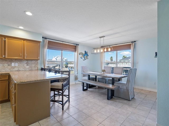 dining space with baseboards, recessed lighting, light tile patterned floors, and a textured ceiling