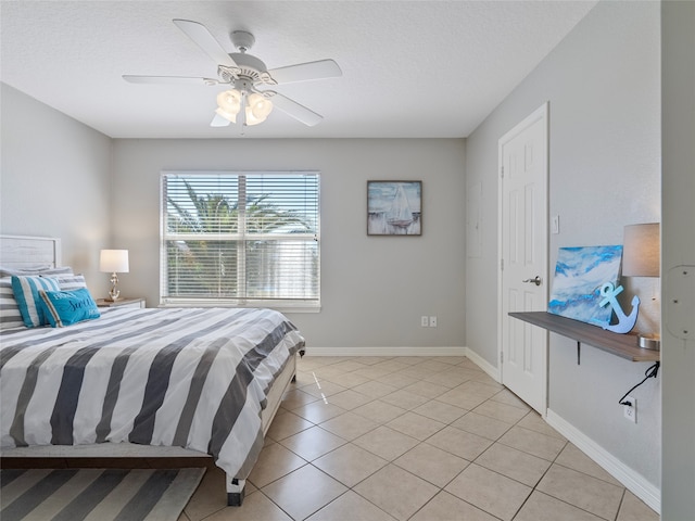 tiled bedroom featuring a textured ceiling and ceiling fan