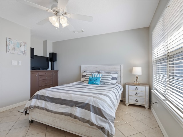 tiled bedroom featuring ceiling fan