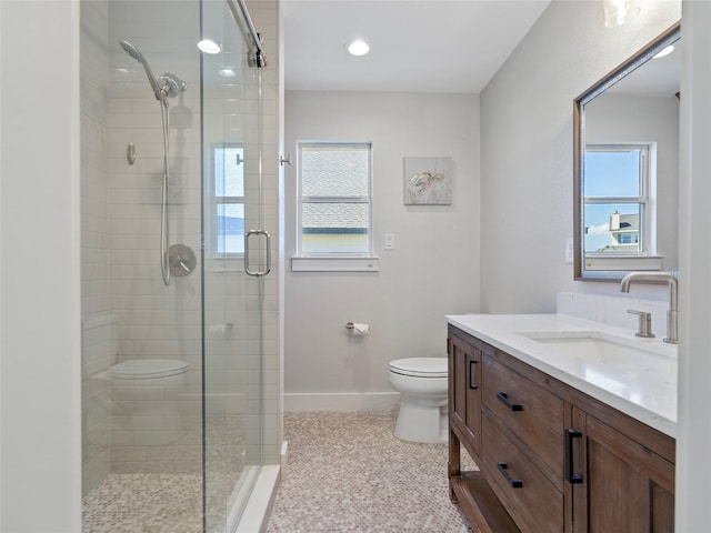 bathroom with a shower stall, baseboards, toilet, recessed lighting, and vanity