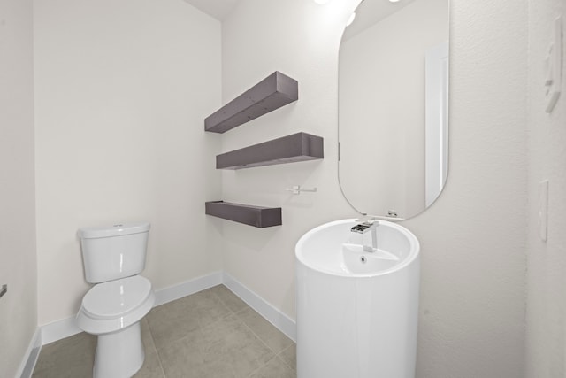 bathroom featuring toilet and tile patterned floors