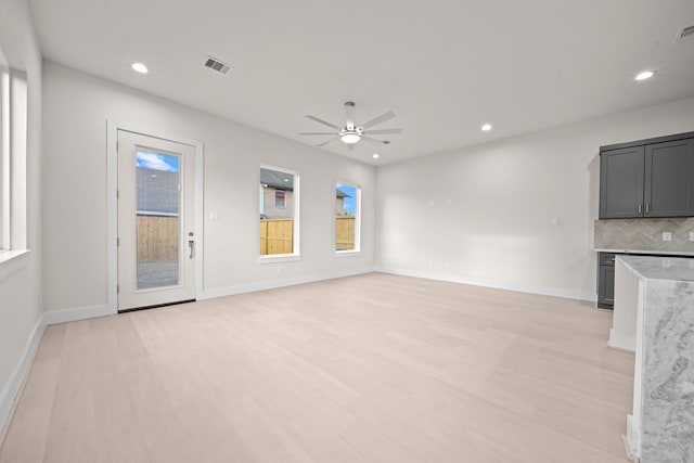 unfurnished living room featuring light hardwood / wood-style floors and ceiling fan