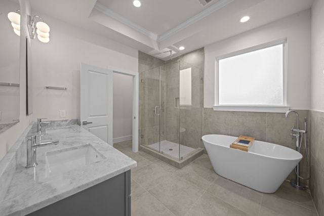 bathroom featuring vanity, crown molding, independent shower and bath, and tile walls