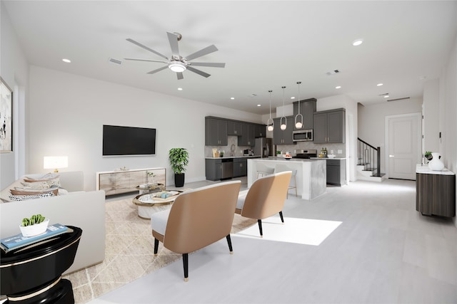 living room with sink and ceiling fan