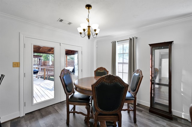 dining room with a notable chandelier, ornamental molding, dark wood-type flooring, and plenty of natural light