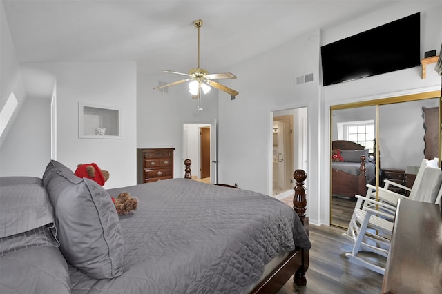 bedroom featuring wood-type flooring, ceiling fan, a closet, and high vaulted ceiling