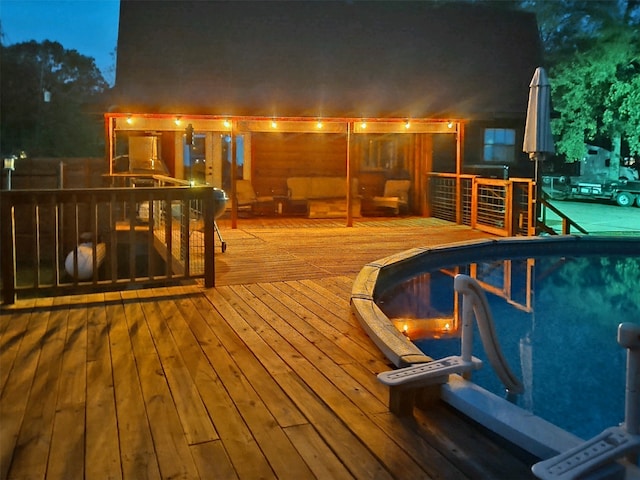 pool at twilight featuring a deck