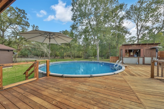 view of pool with a yard and a wooden deck