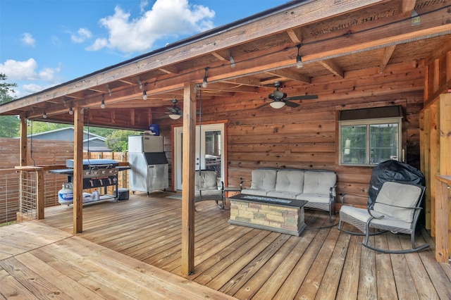 wooden terrace featuring area for grilling, ceiling fan, and an outdoor hangout area