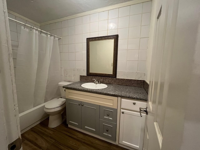 full bath featuring crown molding, wood finished floors, vanity, tile walls, and toilet