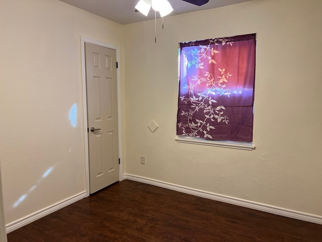 spare room featuring ceiling fan and dark hardwood / wood-style floors