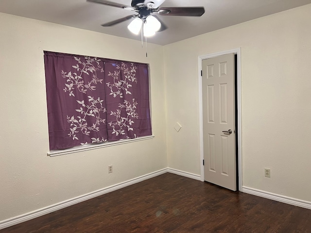 unfurnished room with ceiling fan and dark hardwood / wood-style floors