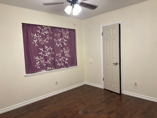 empty room featuring ceiling fan and dark wood-type flooring