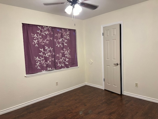 spare room with wood finished floors, baseboards, and ceiling fan