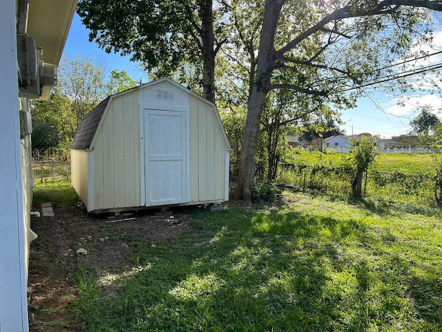 view of shed featuring fence