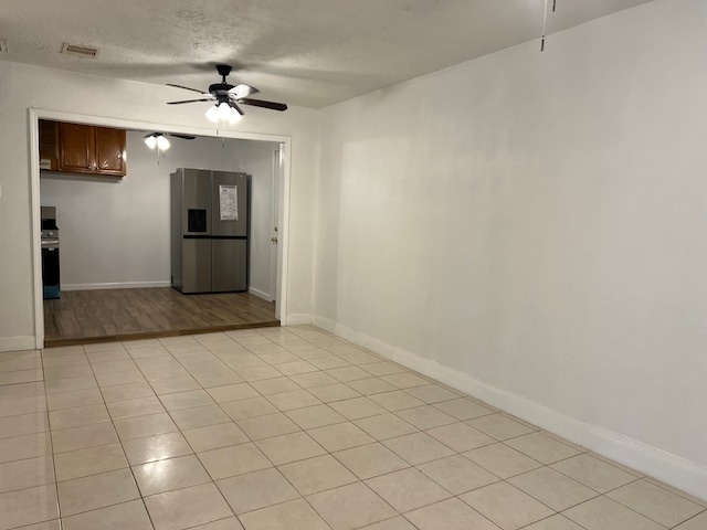 interior space featuring a textured ceiling, ceiling fan, and light hardwood / wood-style flooring