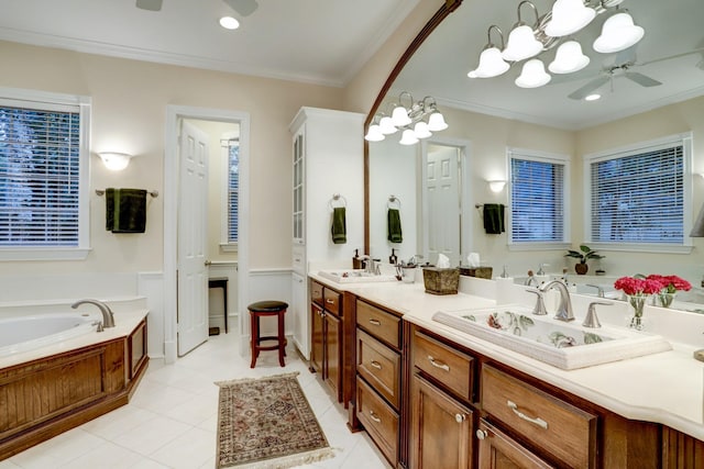 bathroom featuring a tub to relax in, vanity, ceiling fan with notable chandelier, crown molding, and tile patterned flooring