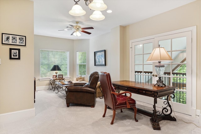 carpeted home office featuring ceiling fan