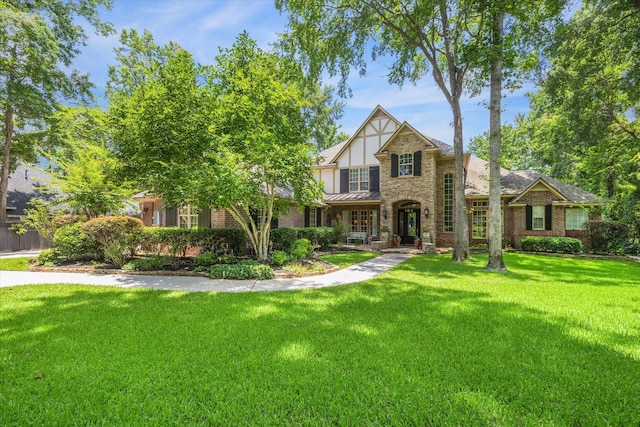 tudor home featuring a front yard