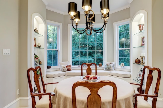 dining room with crown molding and an inviting chandelier