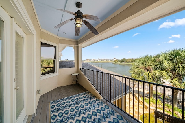 balcony featuring a water view and ceiling fan