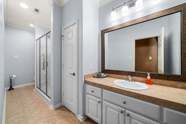 bathroom with tile patterned flooring, a shower with door, vanity, and crown molding